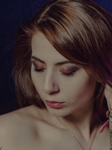 Soft studio portrait of byliv looking down