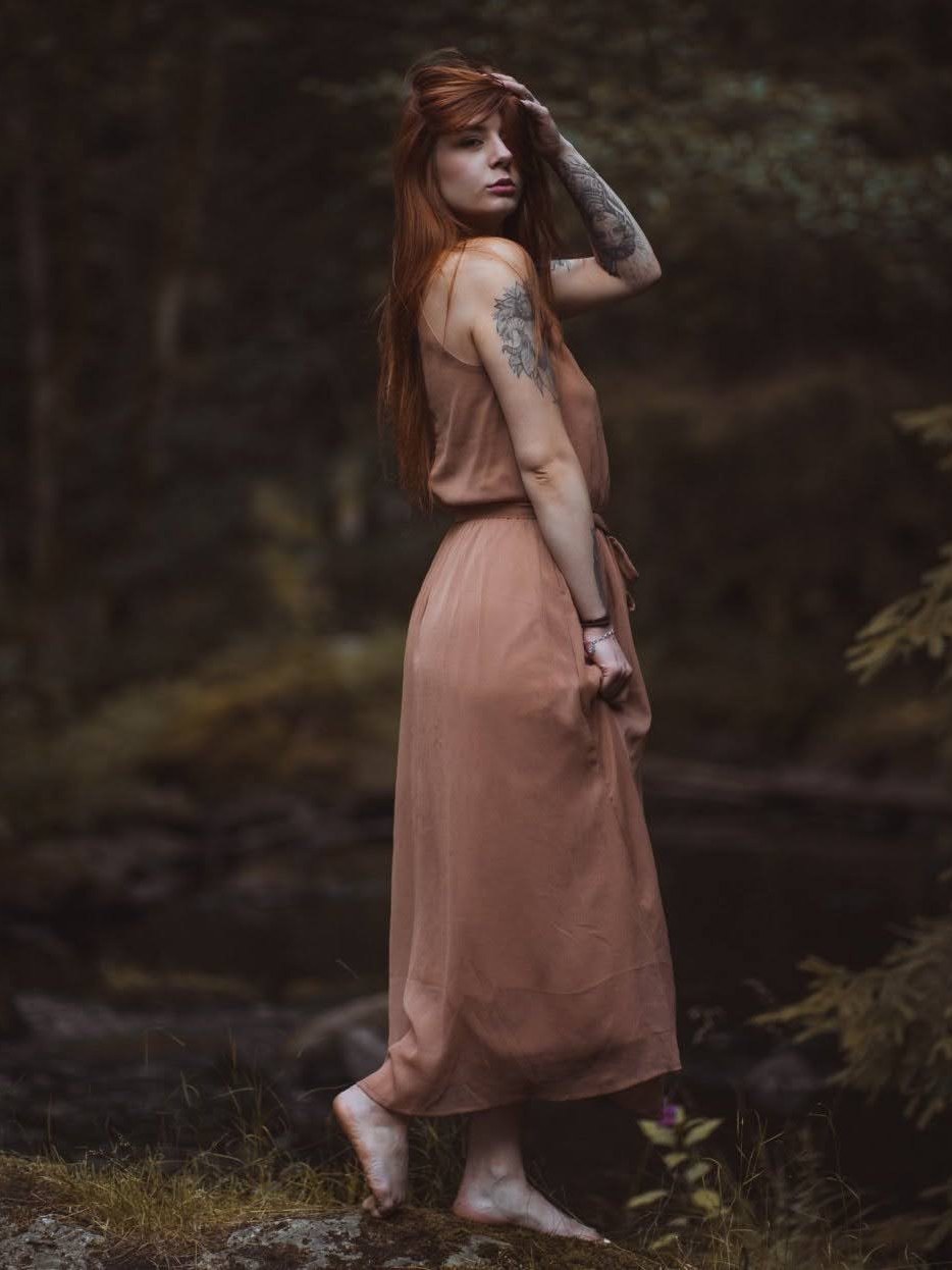 byliv in a rose silk dress in the forest